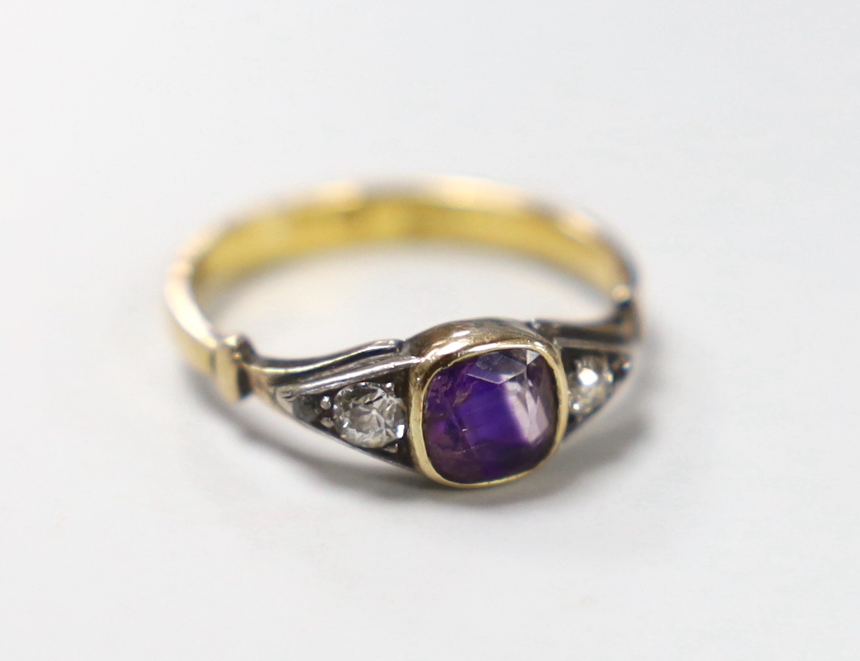 An antique 22ct gold and collet set amethyst ring, with graduated diamond set shoulders, size K, gross weight 2.6 grams.